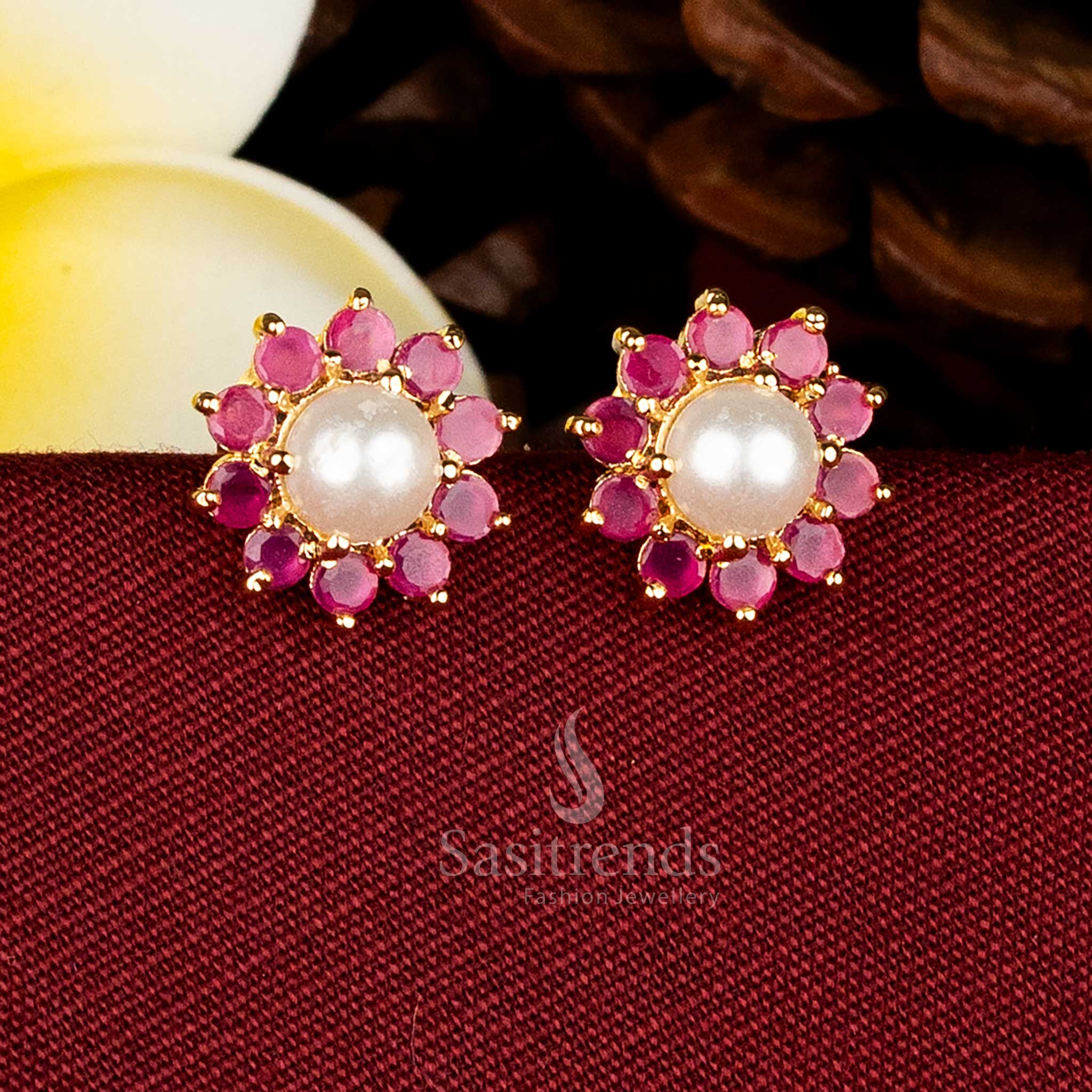 Gold plated round floral stud earrings adorned with AD stones and pearls for elegant occasions Sasitrends