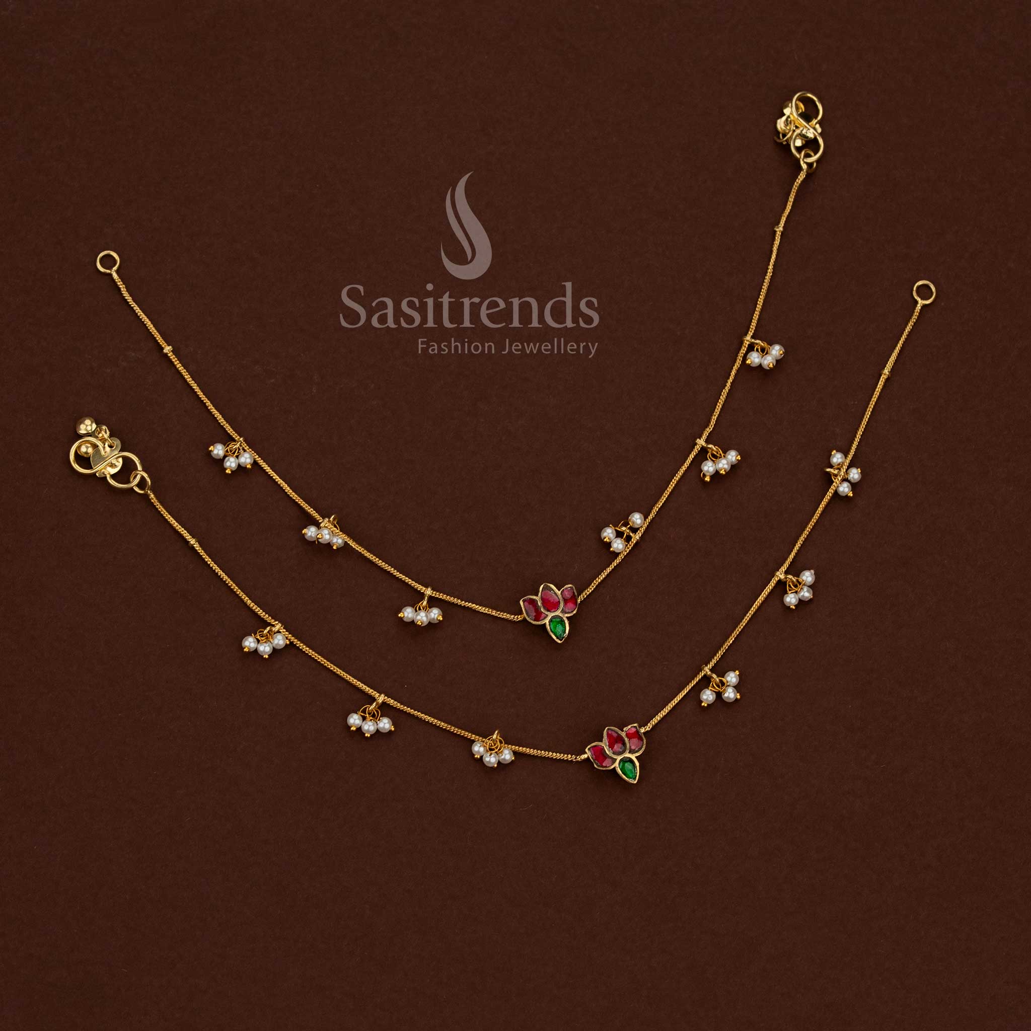
24K jadau gold plated kundan stone anklet featuring a collection of floral leaf designs with pearl detailing by Sasitrends
