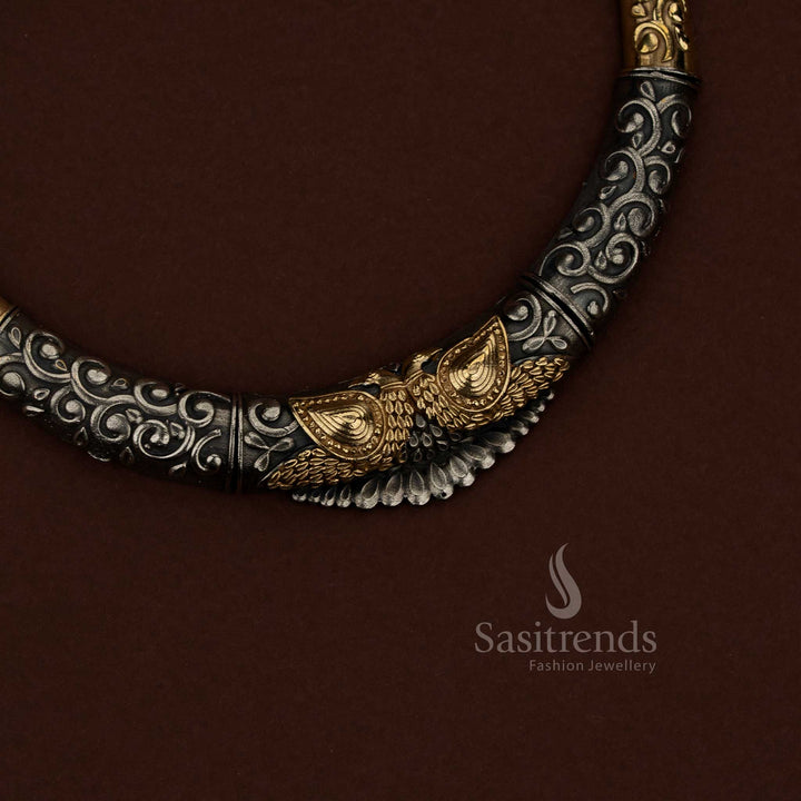 Sasitrends oxidised silver husli necklace jewellery set showcasing detailed floral embossing combined with sculpted peacock motif design, continuous engraved scrollwork across the curved structure, dual tone surface detailing, and coordinated earrings reflecting floral and peacock design elements suitable for festive and cultural occasions.