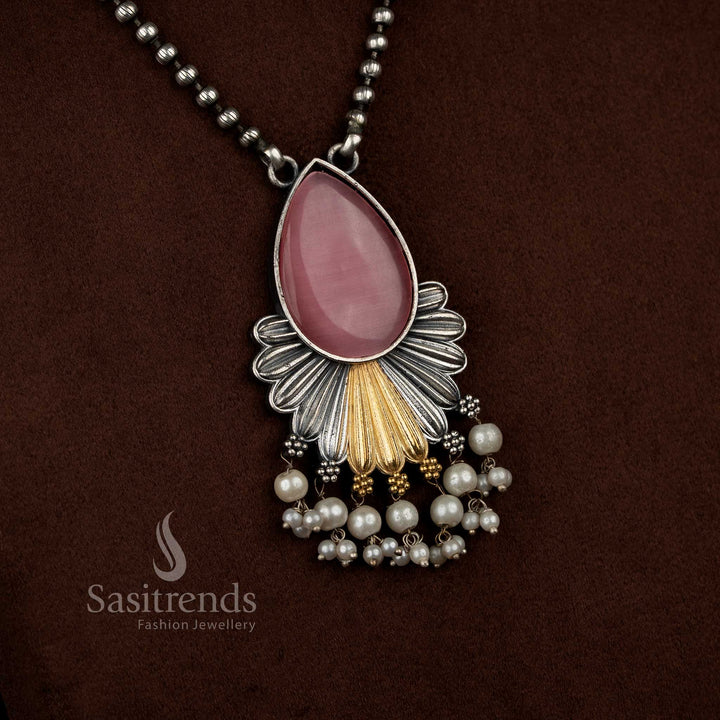 Antique oxidised 92.5 silver plated Monalisa stone necklace jewellery set in pink tone, crafted with a teardrop floral pendant design, layered silver structure, gold tone detailing, pearl bead danglers, oxidised bead chain, and matching floral motif earrings
