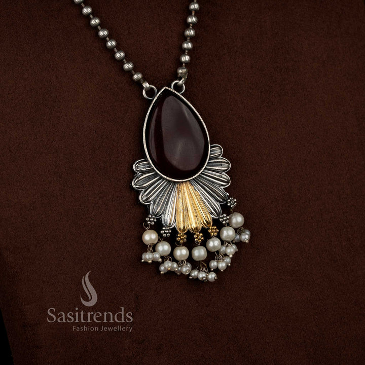 Antique oxidised 92.5 silver plated Monalisa stone necklace set in red shade, crafted with a floral inspired layered drop pendant, detailed silver textures, gold tone accents, pearl bead hangings, oxidised beaded chain, and matching floral drop earrings - Sasitrends
