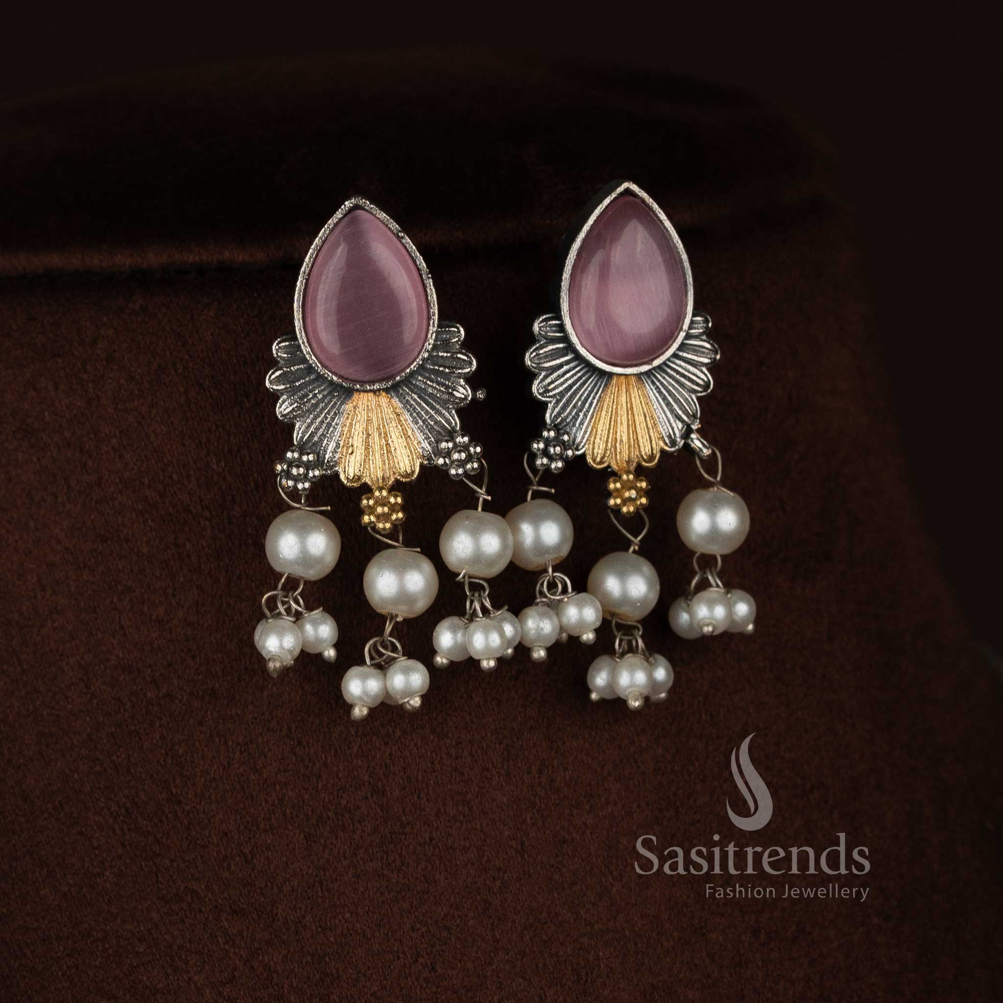 Antique oxidised 92.5 silver plated pink Monalisa stone necklace jewellery set featuring a structured floral drop pendant, layered silver detailing, pearl bead hangings, oxidised beaded chain, and matching earrings displayed on a dark background - Sasitrends
