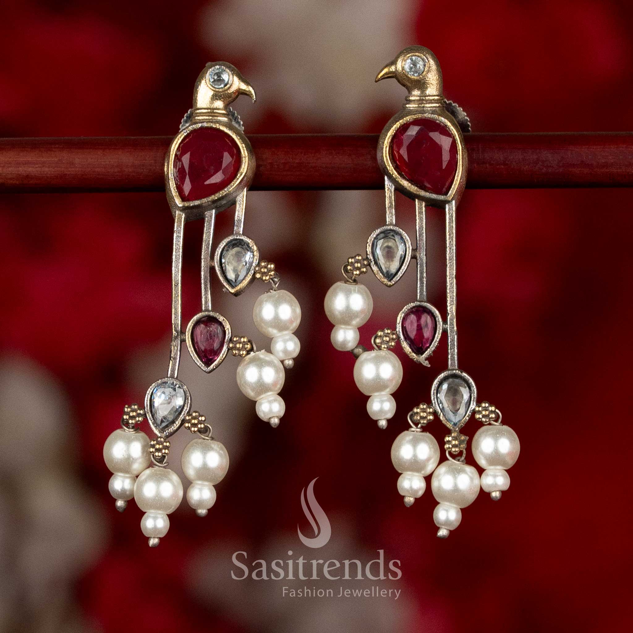 Dual tone silver plated parrot motif long drop earrings with stone detailing and layered pearl bead hangings for ethnic wear - Sasitrends
