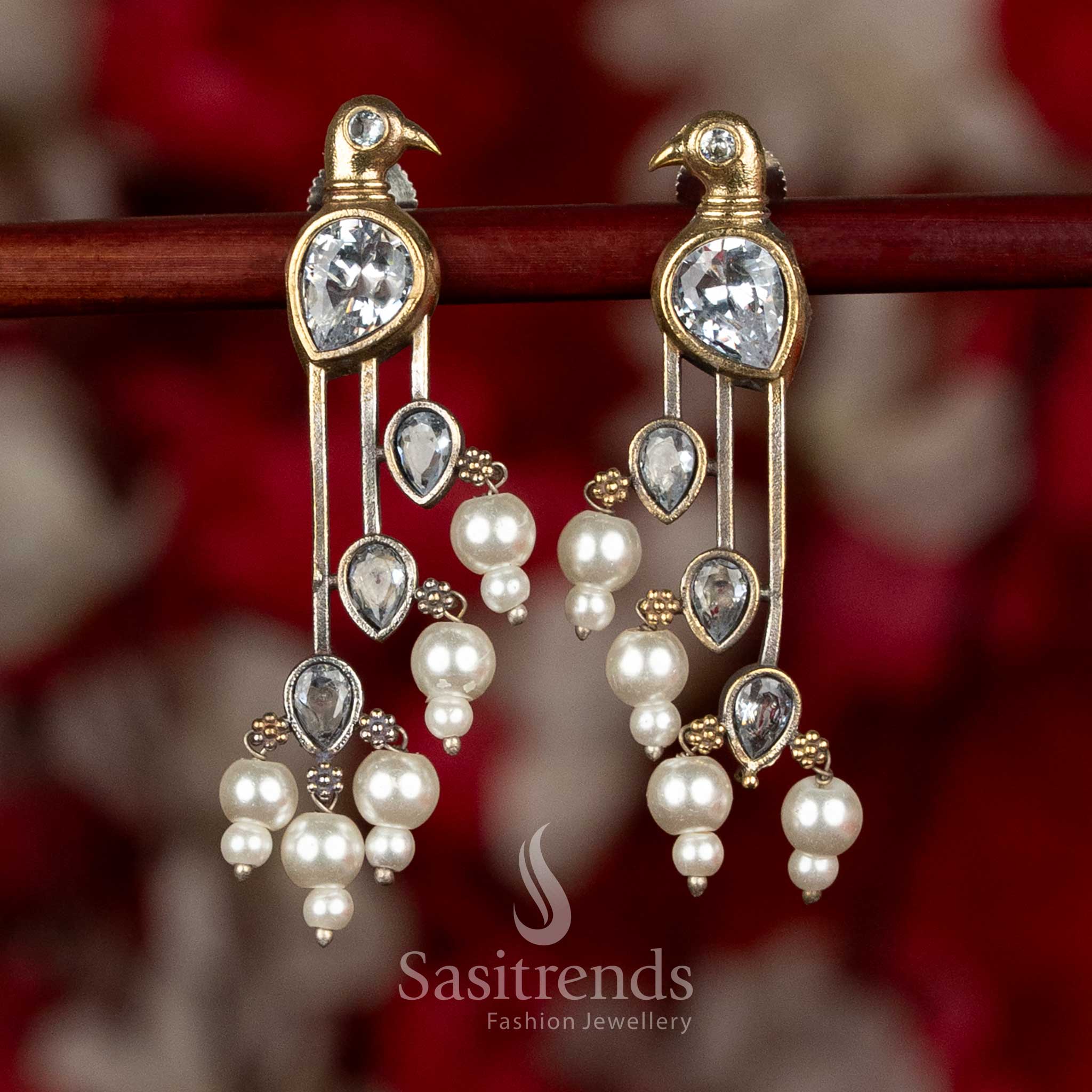 
Sasitrends oxidised silver parrot motif earrings in elegant white colour showcasing elongated structure and pearl hangings for refined ethnic styling
