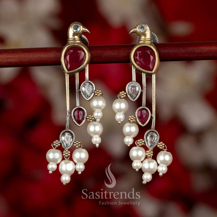 Sasitrends parrot inspired oxidised silver earrings featuring red and white colour accents with structured long drop design and pearl detailing
