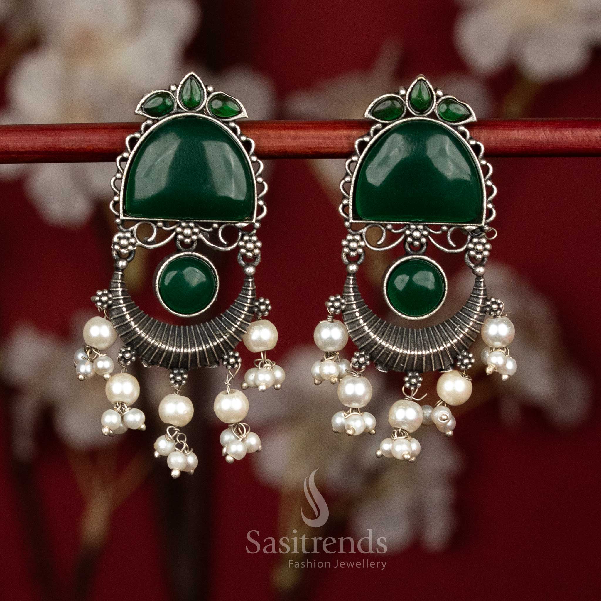 Attractive antique oxidised 92.5 silver earrings featuring green Monalisa stones, graceful arch and crescent form with flowing pearl tassel hangings for elegant party styling - Sasitrends