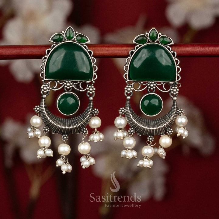 Attractive antique oxidised 92.5 silver earrings featuring green Monalisa stones, graceful arch and crescent form with flowing pearl tassel hangings for elegant party styling - Sasitrends