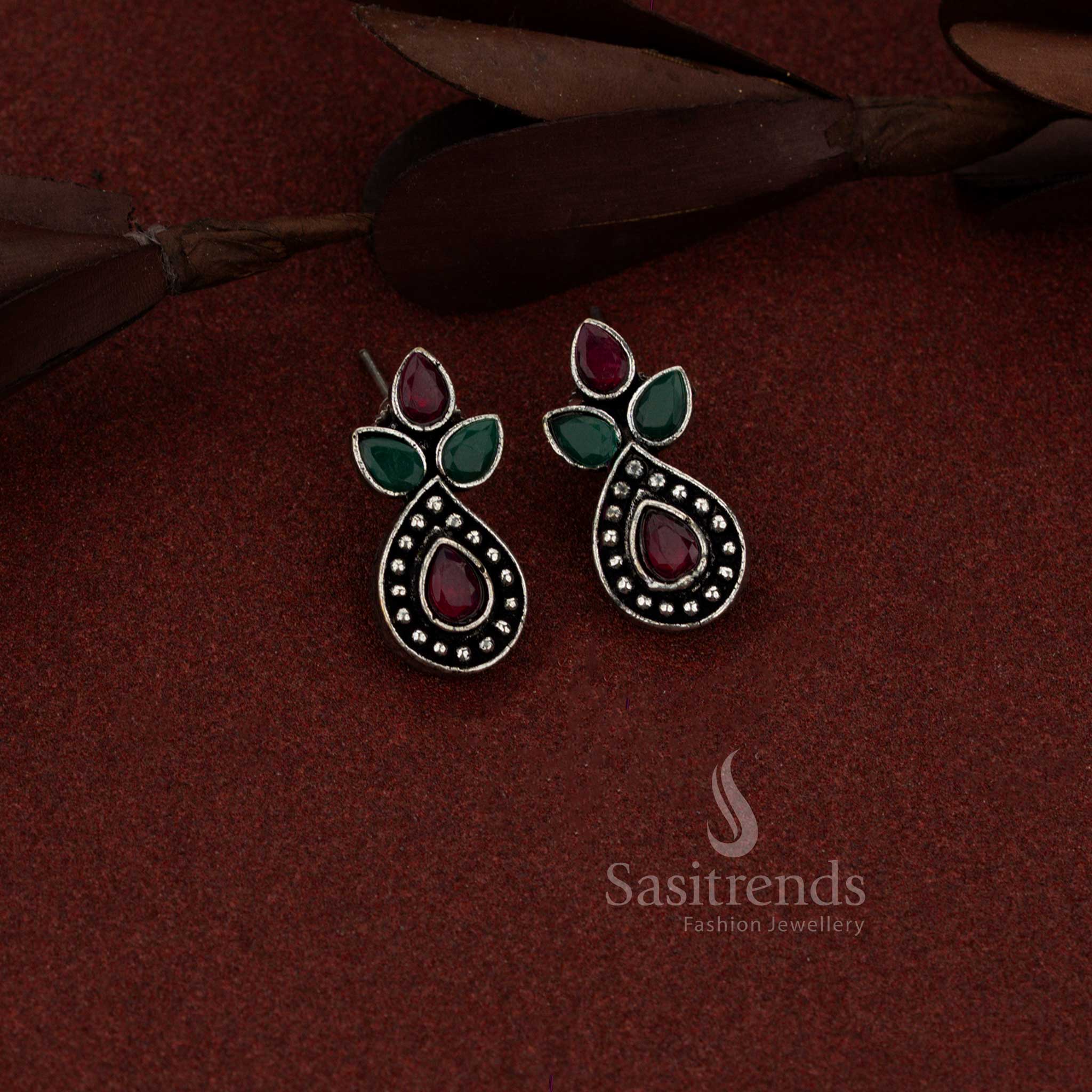 Sasitrends versatile oxidised silver stud earrings designed with trifoliate teardrop red green stone arrangement for everyday wear