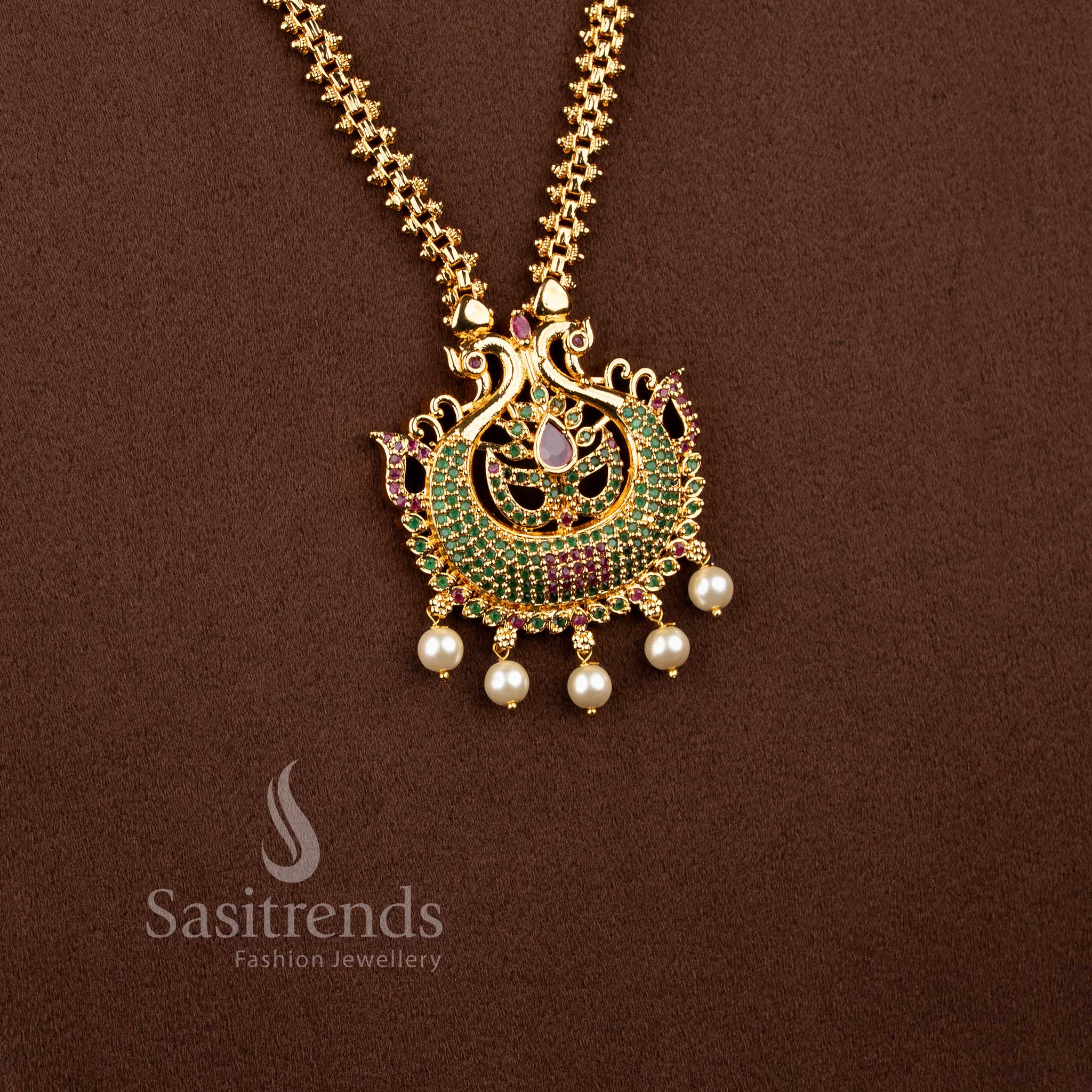 Dynasty gold toned necklace in ruby green portraying peacock form, pear shine and pearls – Sasitrends