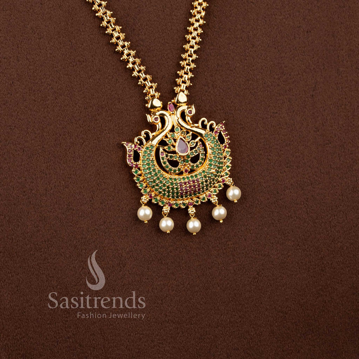 Dynasty gold toned necklace in ruby green portraying peacock form, pear shine and pearls – Sasitrends
