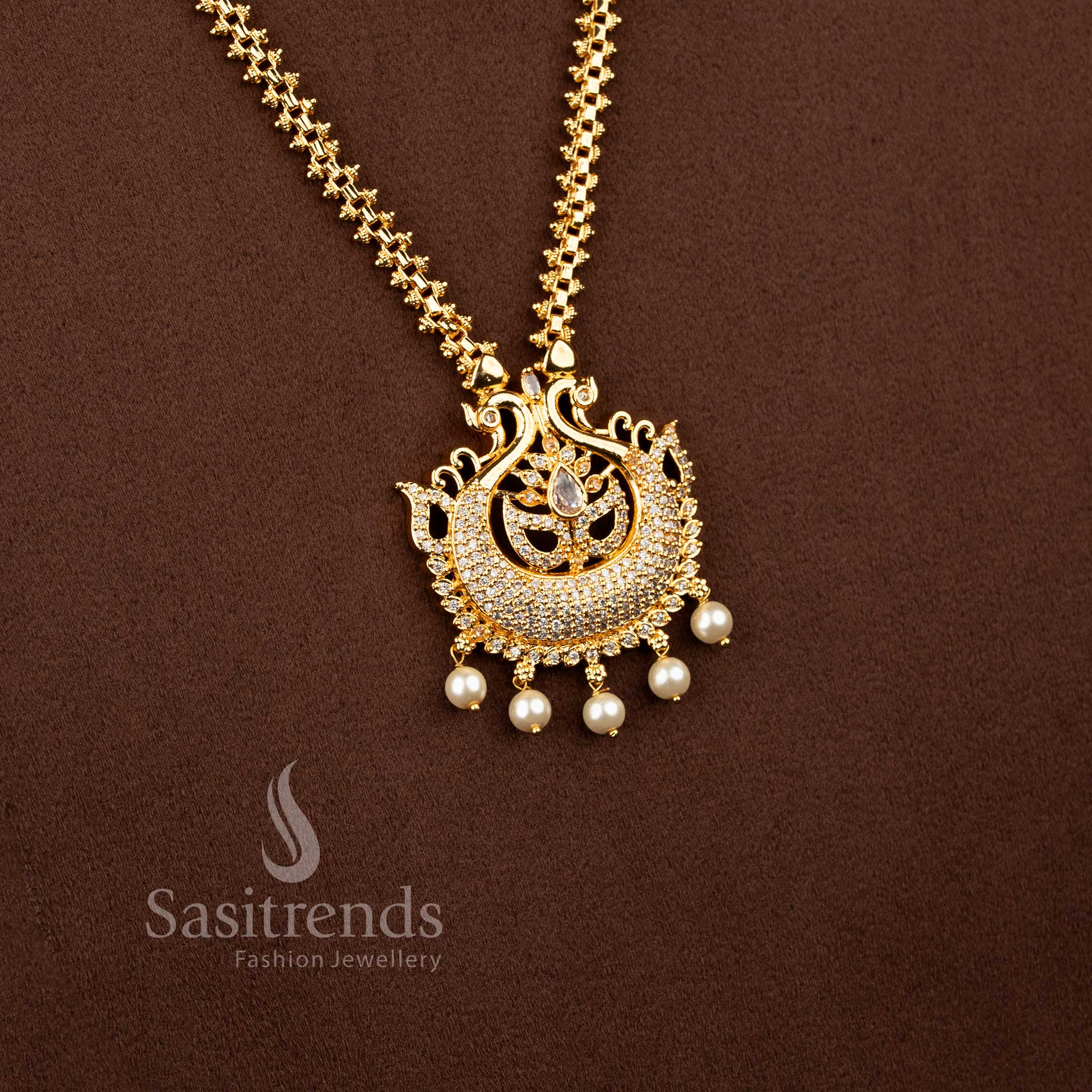 Divine gold toned necklace in white portraying peacock elegance enhanced with pear glow and pearls – Sasitrends