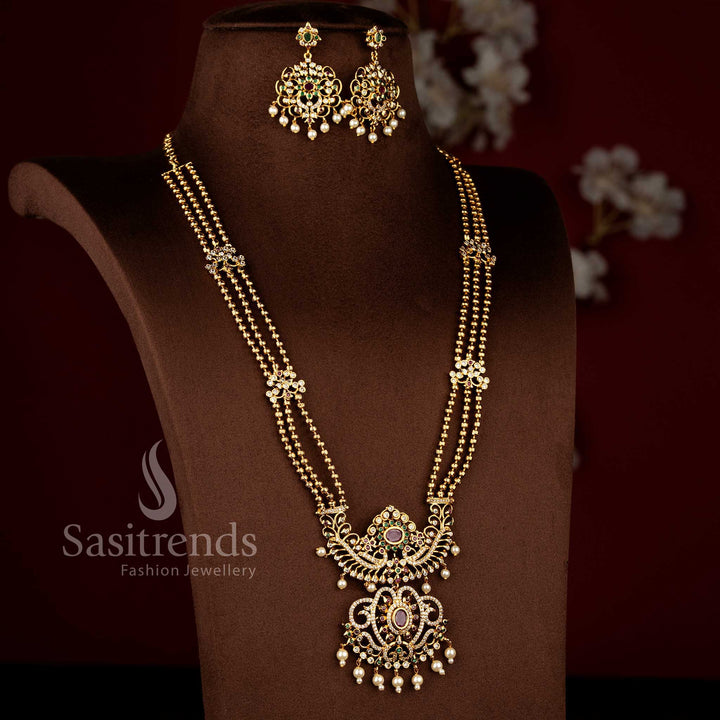 Sasitrends temple matte gold plated multi AD stone three layer long haram necklace jewellery set with peacock and floral pendant motifs