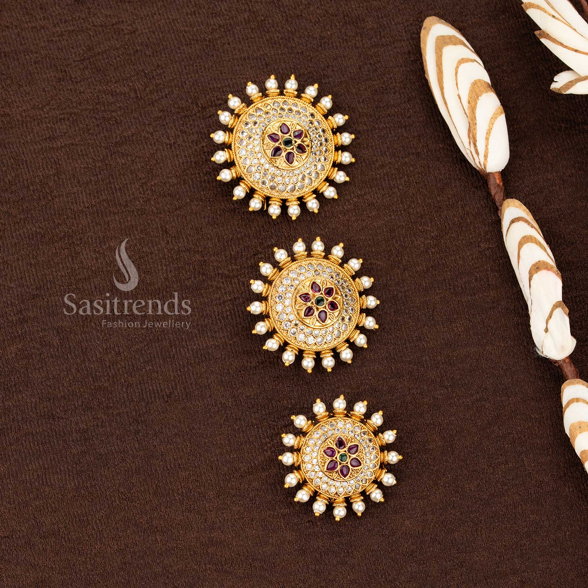 Sasitrends temple matte gold plated floral medallion jadai billai with layered circular multi AD stone structure and pearl drop border