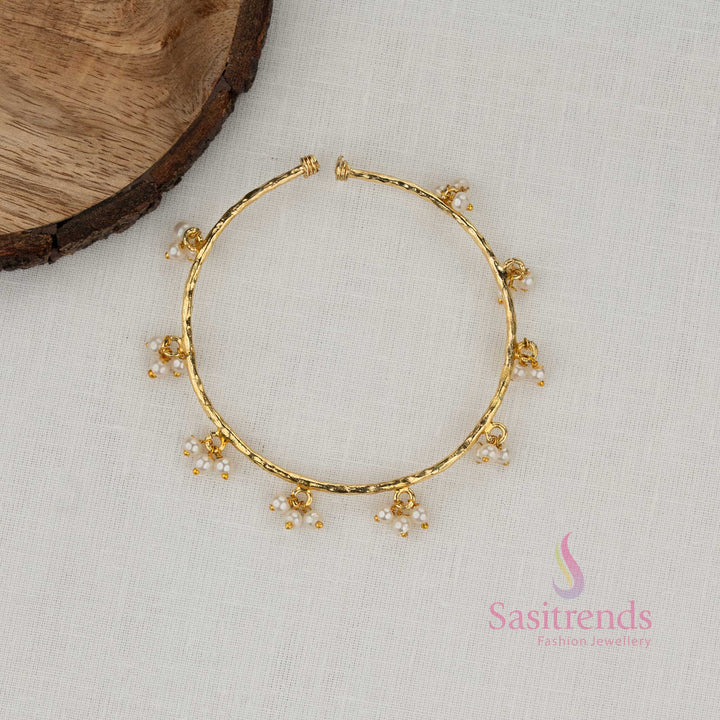 Trendy Gold Plated Charm Bracelet for Girls with Textured Design and Delicate Hanging Pearl Accents | Party Wear Fashion Jewellery