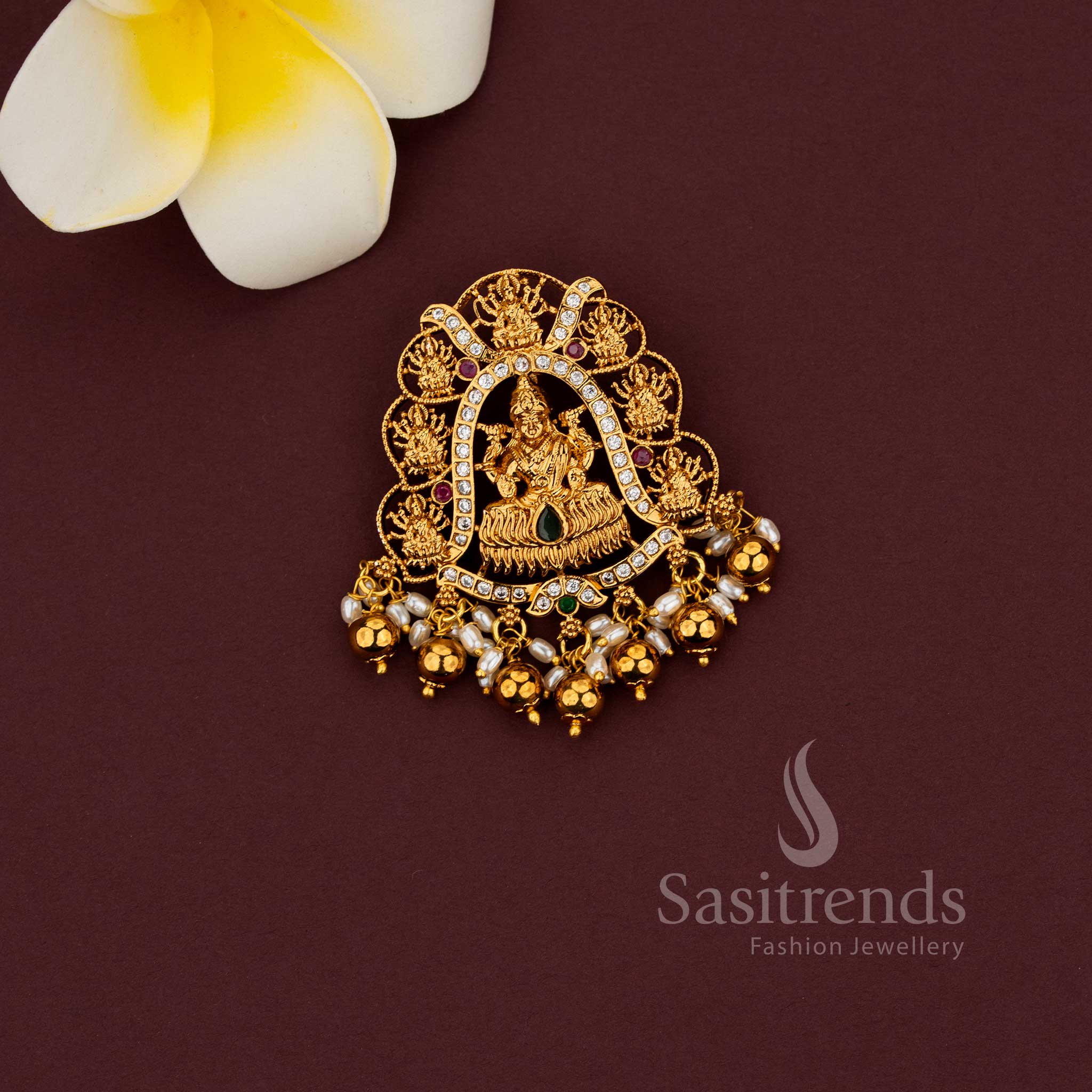 	Temple jewellery pendant featuring Gaja Lakshmi motif and intricate detailing 