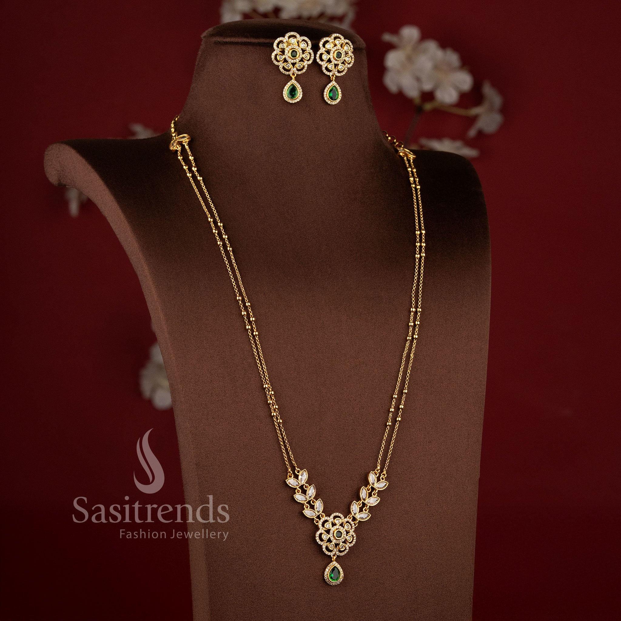 Elegant Two Line Floral Necklace Set with Green center stones, sparkling AD stones, and traditional matte gold styling - Sasitrends