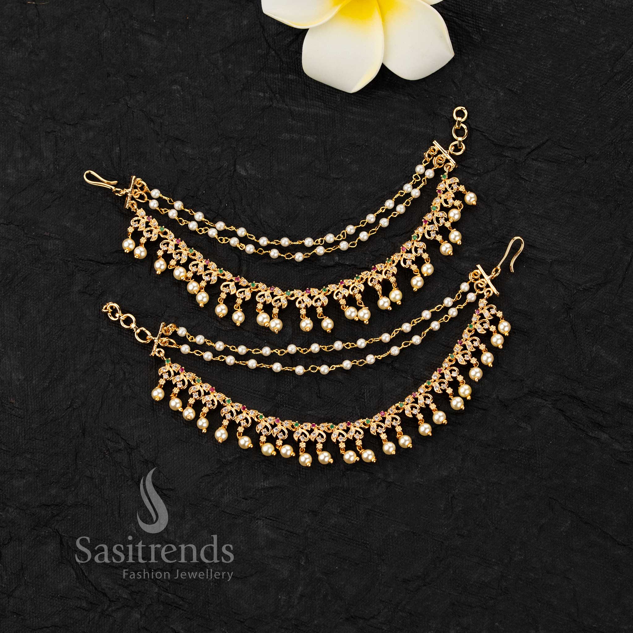 Micro gold plated ear chains featuring motif with AD stones and pearl drop detailing in elegant design