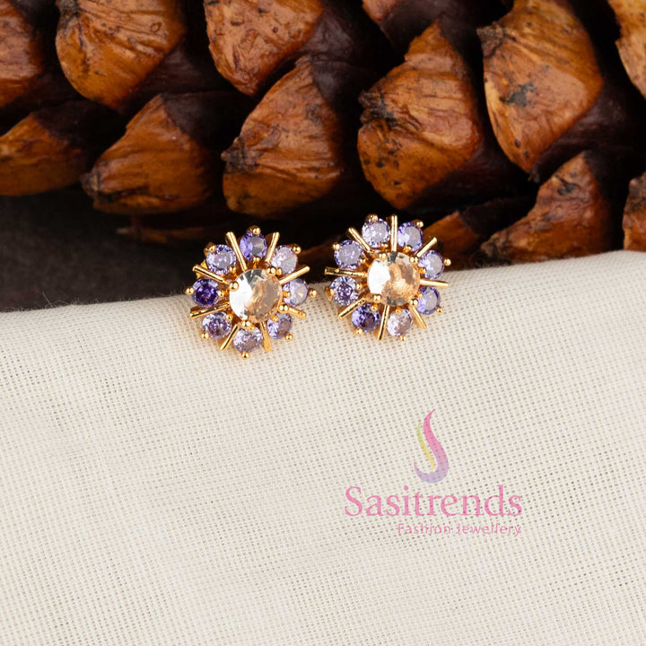 Trendy gold plated purple white American Diamond stud earrings with swirl floral pattern.