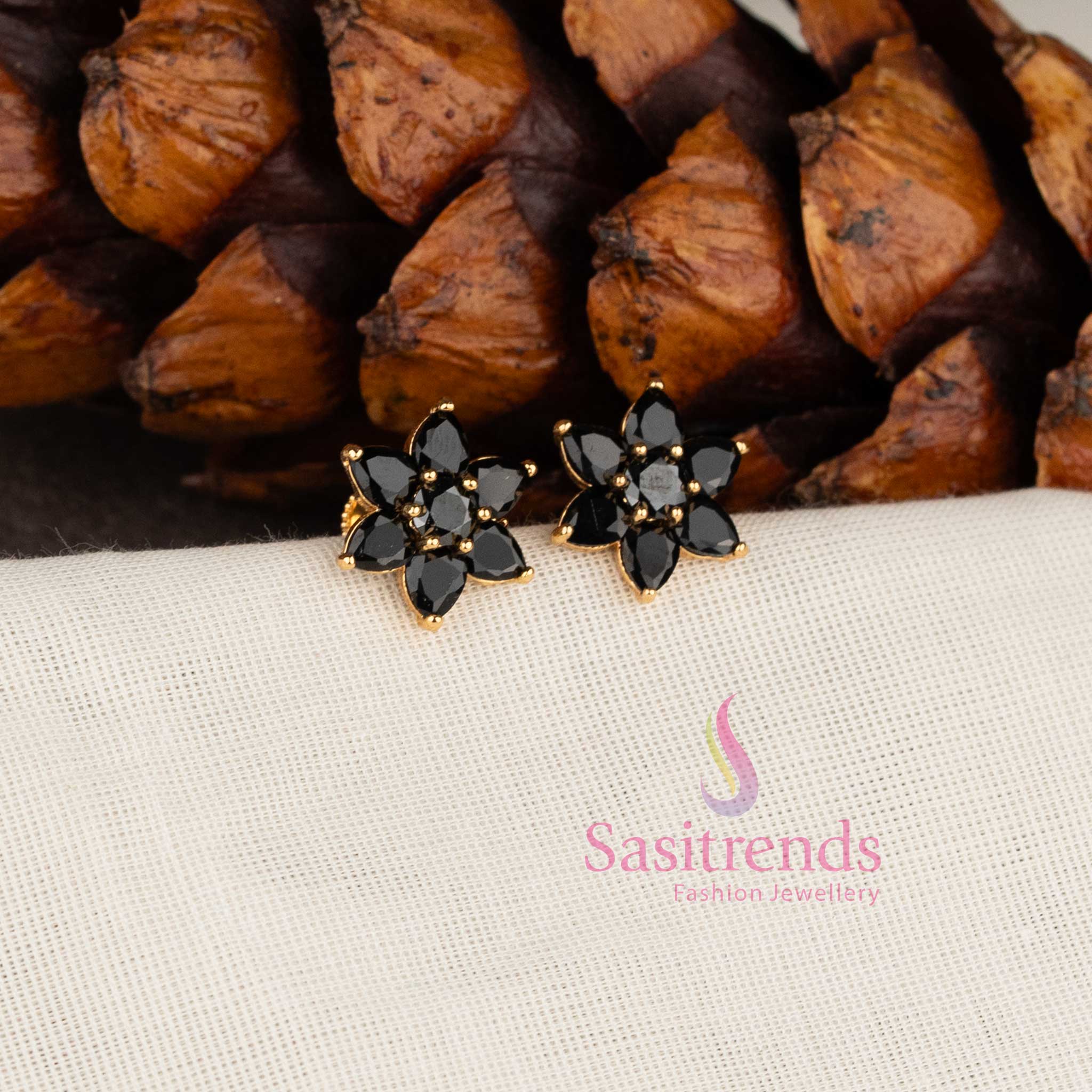 Stylish micro gold plated floral stud earrings with sparkling black AD stones.