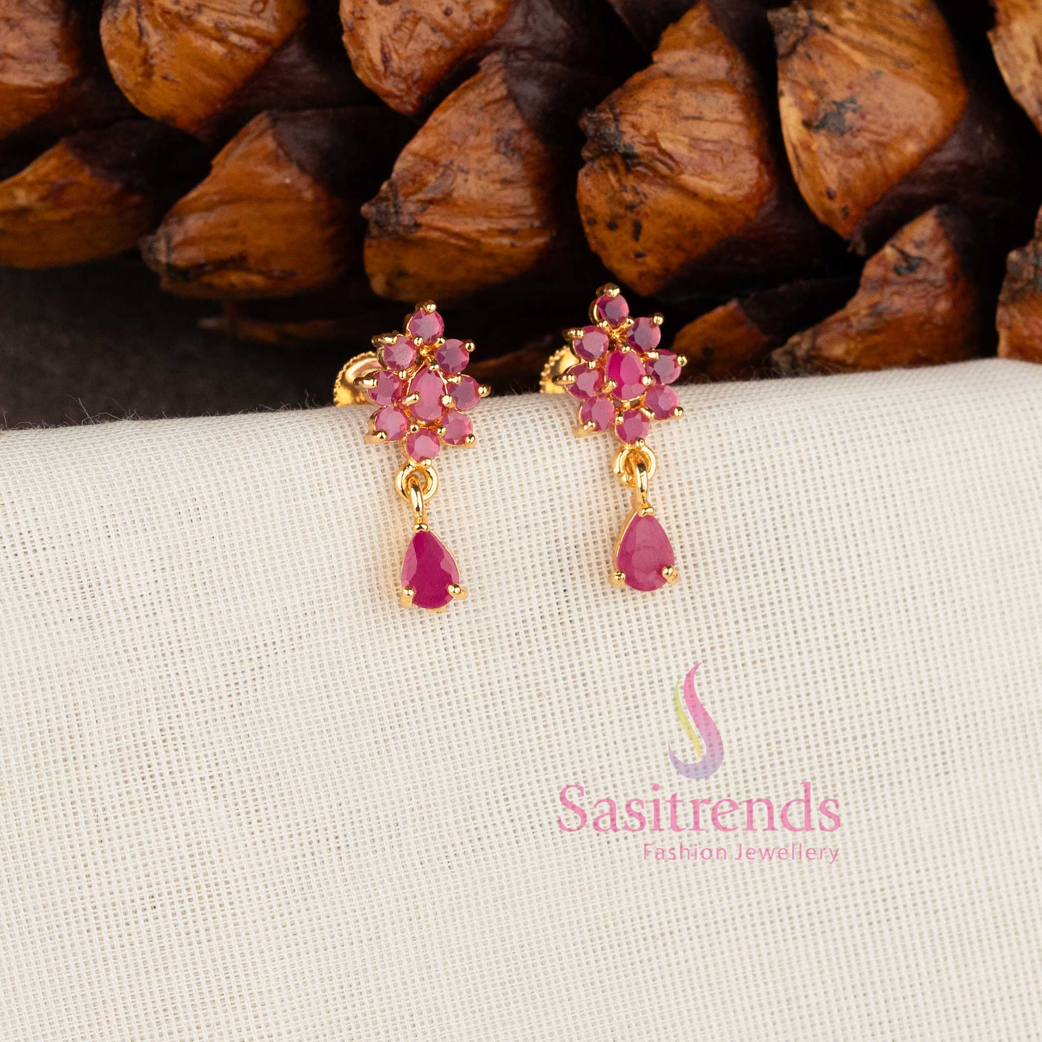 Sparkling micro gold plated American Diamond floral stud earrings with Ruby stones by Sasitrends.