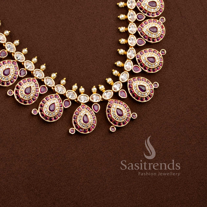 Close-up of an elegant wedding wear interlocking paisley leaf necklace layout with pink stones and pearl bead drops.