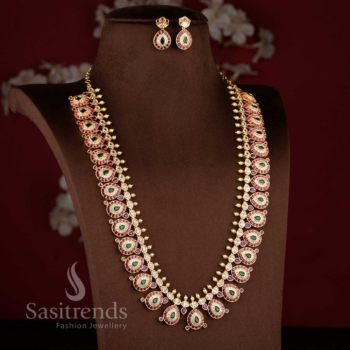 Close-up of an elegant wedding wear interlocking paisley leaf necklace layout with pink stones and pearl bead drops.