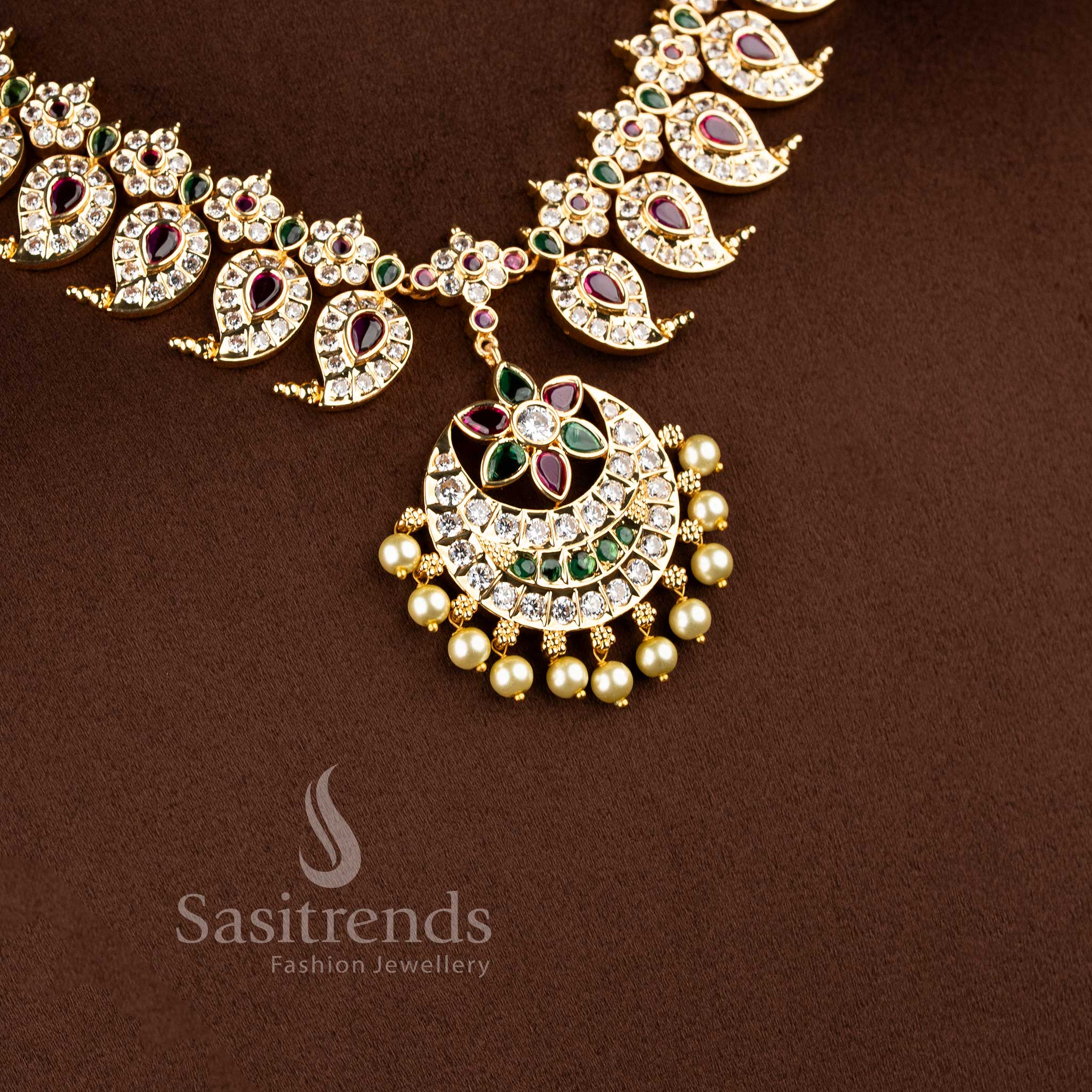 Close-up of interlocking gold mango charms accented with white American Diamonds and colorful gemstones.