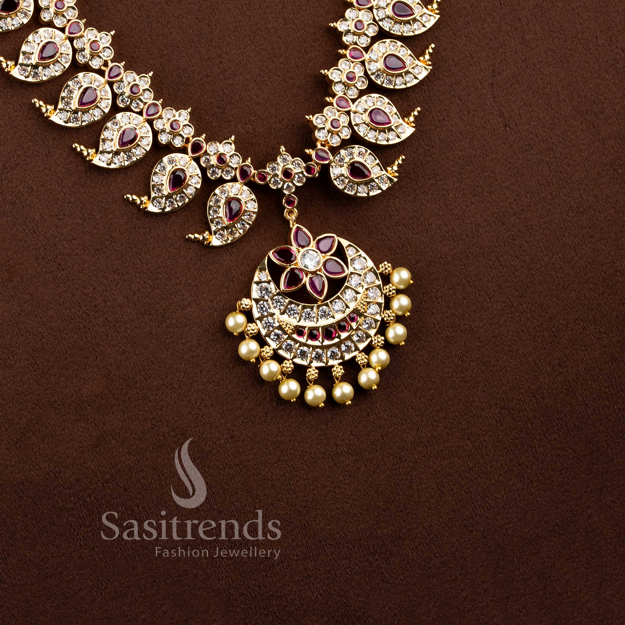 Real gold look wedding wear long necklace showcasing a pearl drop floral blossom centerpiece.