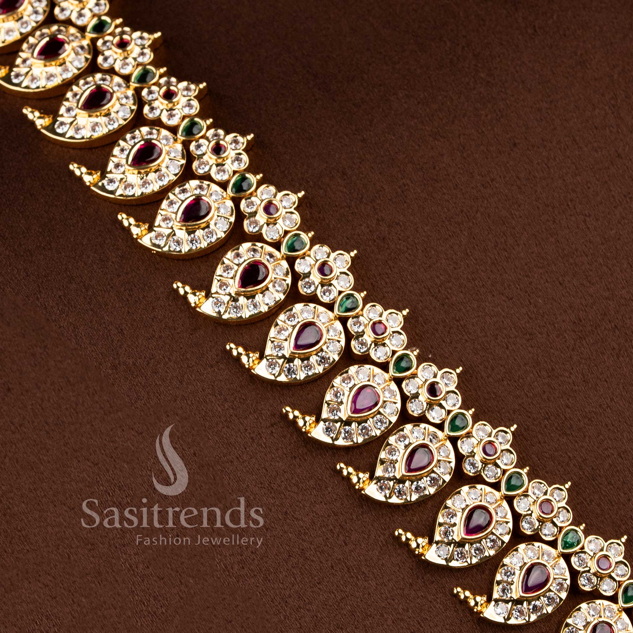 Festive wear south indian style paisley neckpiece beautifully arranged on a brown surface.