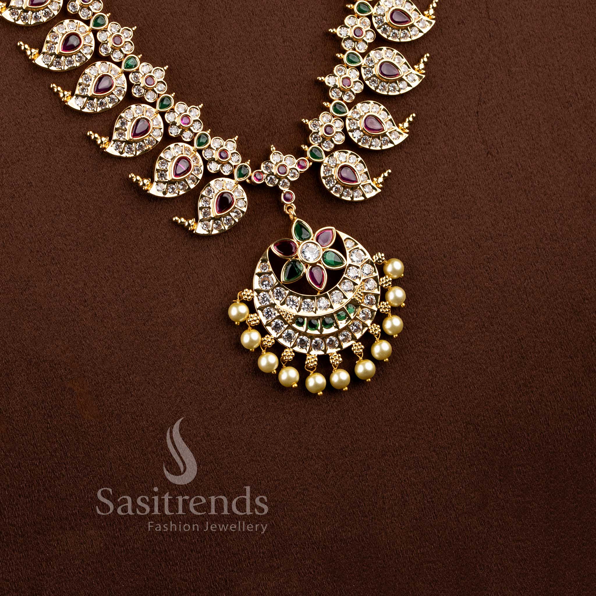 Festive wear south indian style paisley neckpiece beautifully arranged on a brown surface.
