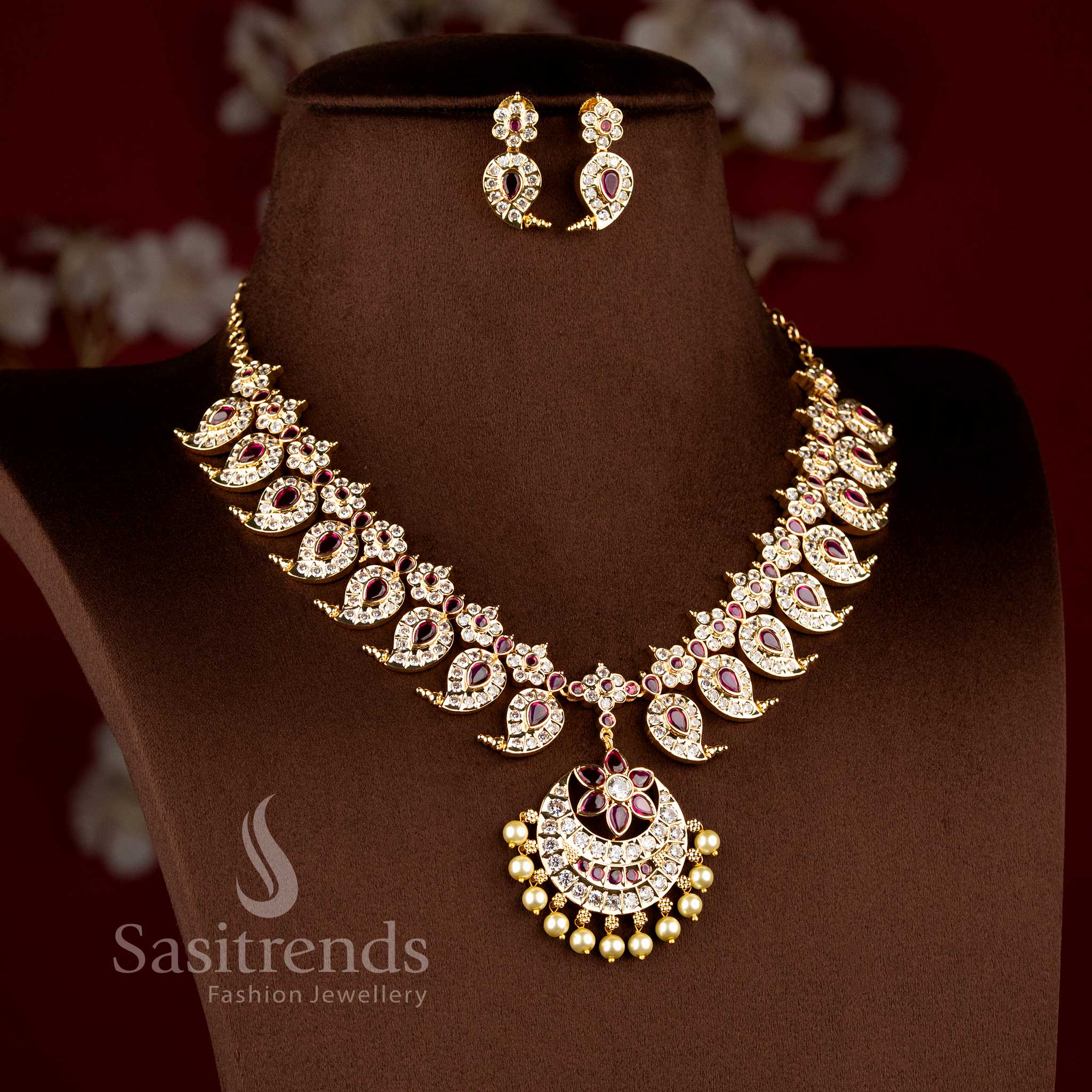 Festive wear south indian style paisley neckpiece beautifully arranged on a brown surface.