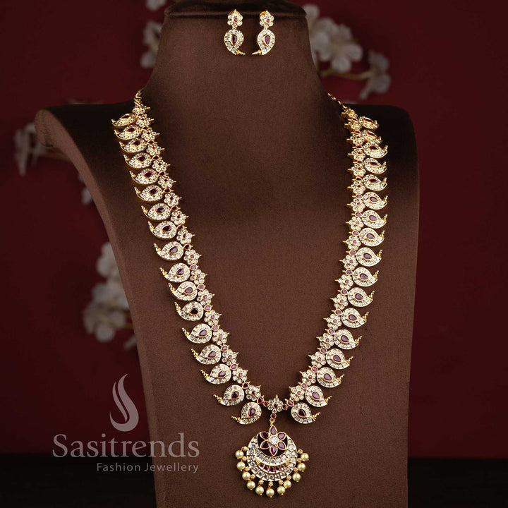 Real gold look wedding wear long necklace set showcasing a pearl drop floral blossom centerpiece.