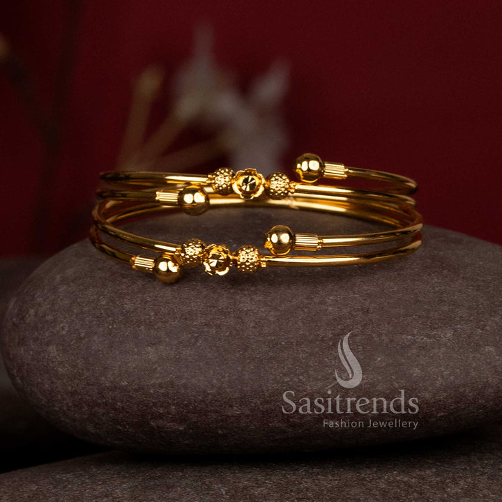 Gorgeous double heart textured ball micro gold plated bypass bangles for festive wear - Sasitrends