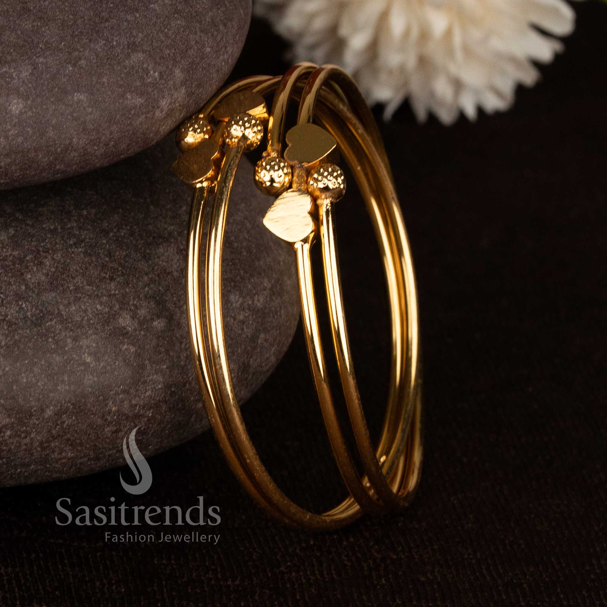 Gorgeous double heart textured ball micro gold plated bypass bangles for festive wear - Sasitrends