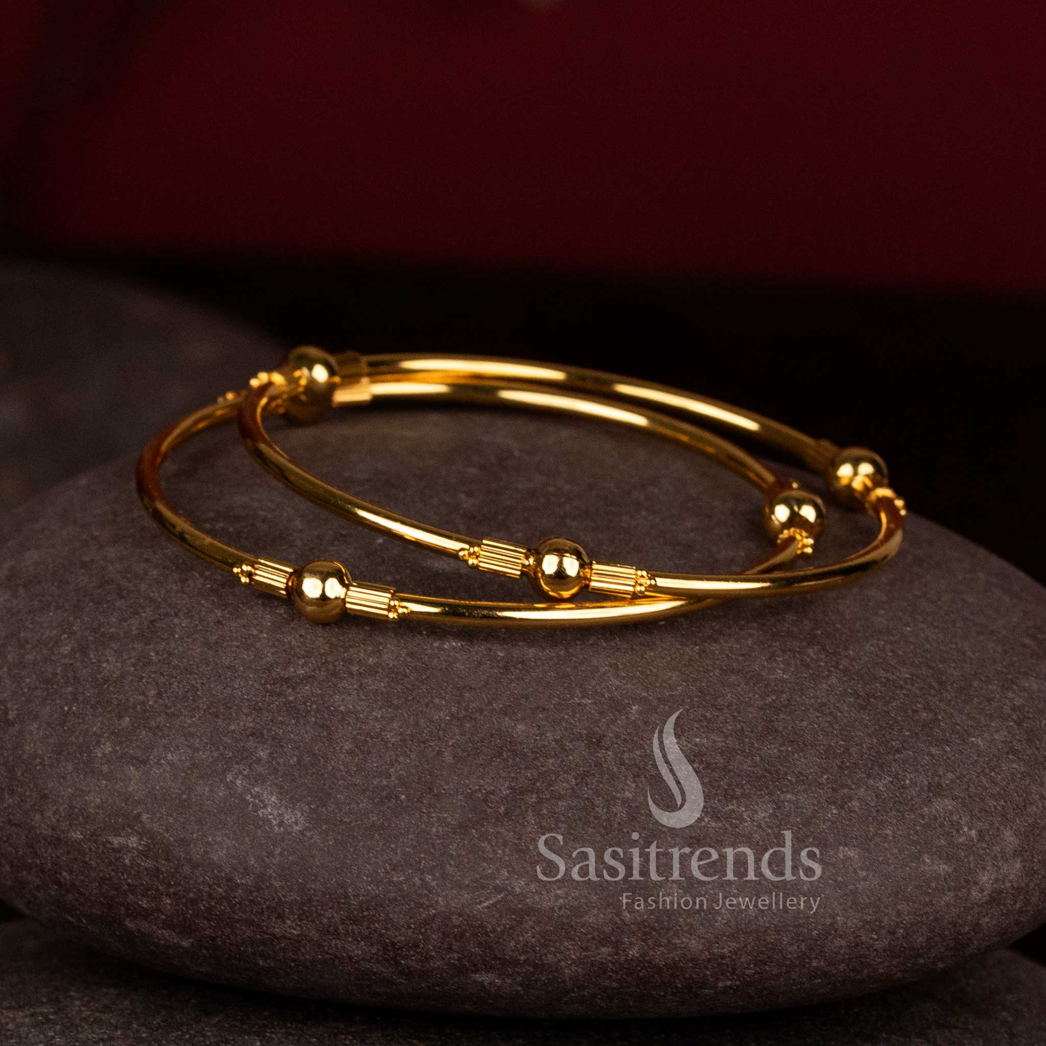 Gorgeous central ball lined spacer micro gold plated bypass bangles for festive wear - Sasitrends