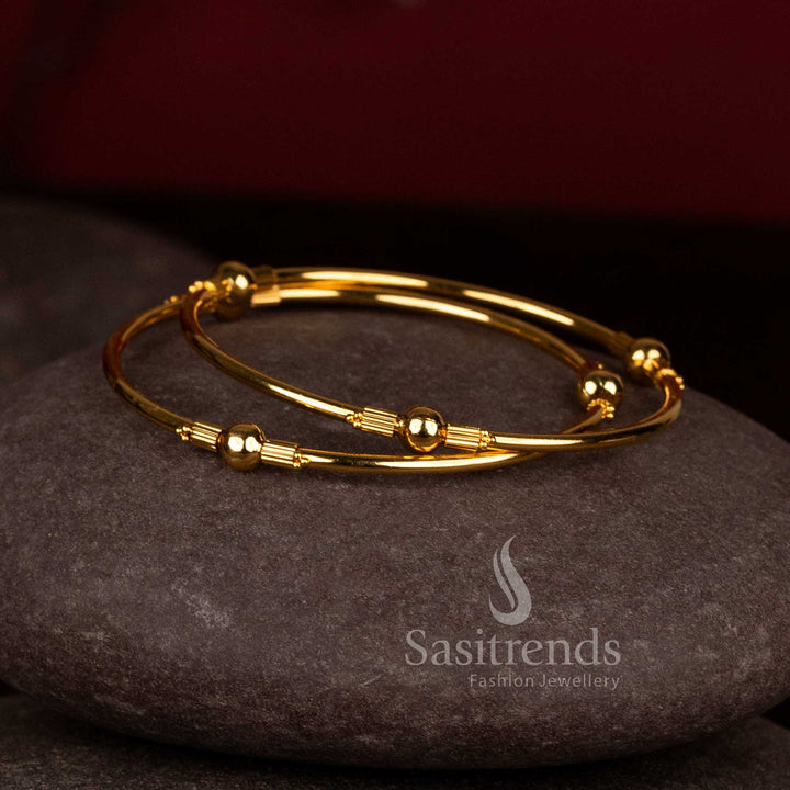 Gorgeous central ball lined spacer micro gold plated bypass bangles for festive wear - Sasitrends