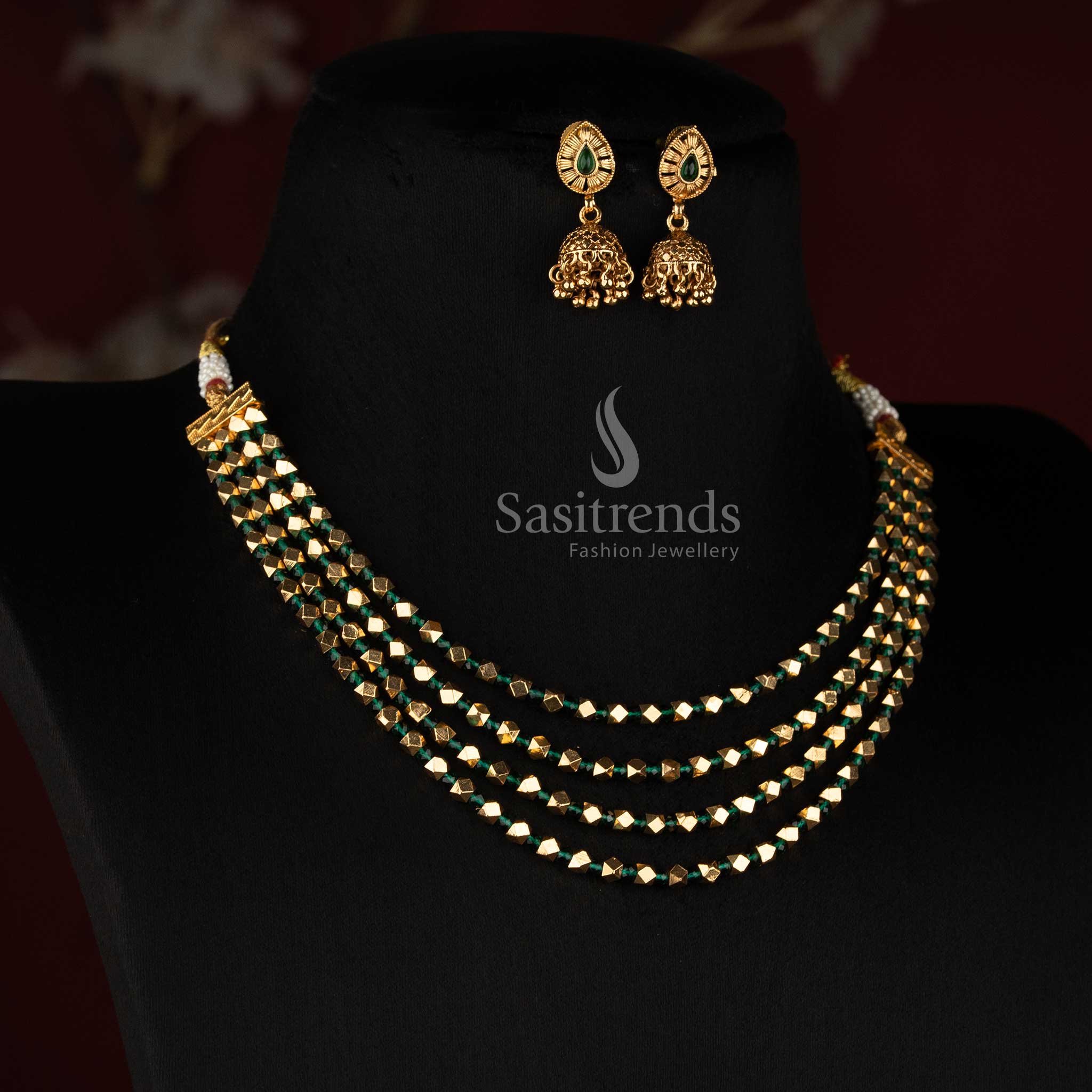 3037G antique gold plated four-row traditional bead necklace with matching teardrop stone Jhumka earrings for festive wear