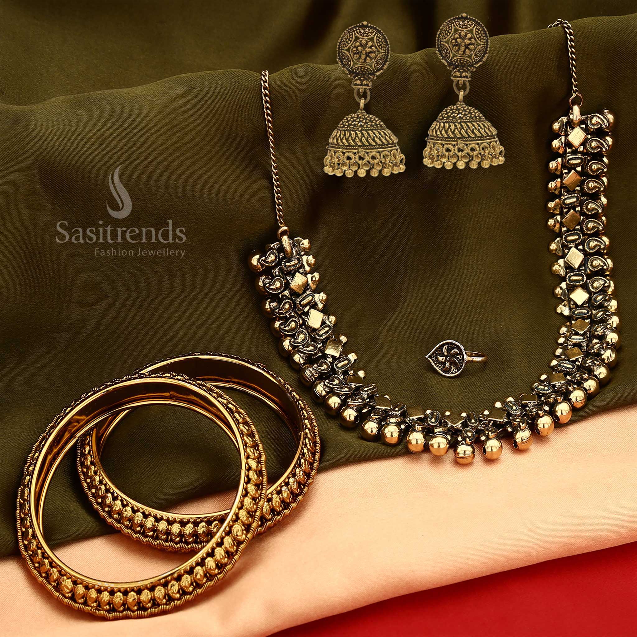 Traditional oxidised antique gold jewellery set featuring a statement short necklace, complementing earrings, a graceful nosepin, and bold bangles – a vintage-inspired set ideal for bridal charm and folk cultural festivities – Sasitrends