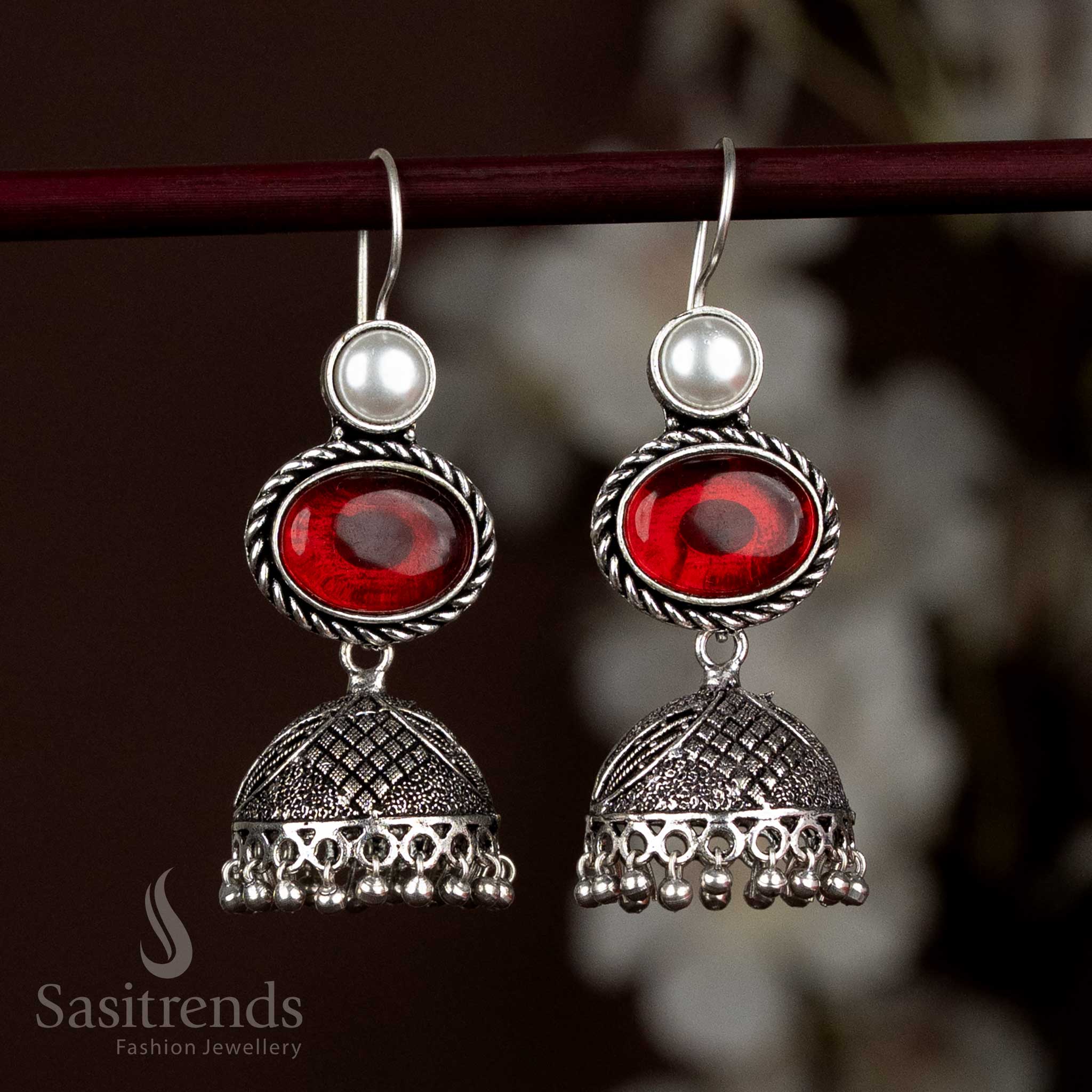 Vibrant Oxidised Silver Jhumka Earrings With Red Oval Stone And Sparkling Pearl Layering, Designed For Striking Festive Statements – Sasitrends