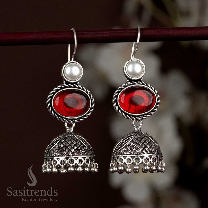 Vibrant Oxidised Silver Jhumka Earrings With Red Oval Stone And Sparkling Pearl Layering, Designed For Striking Festive Statements – Sasitrends