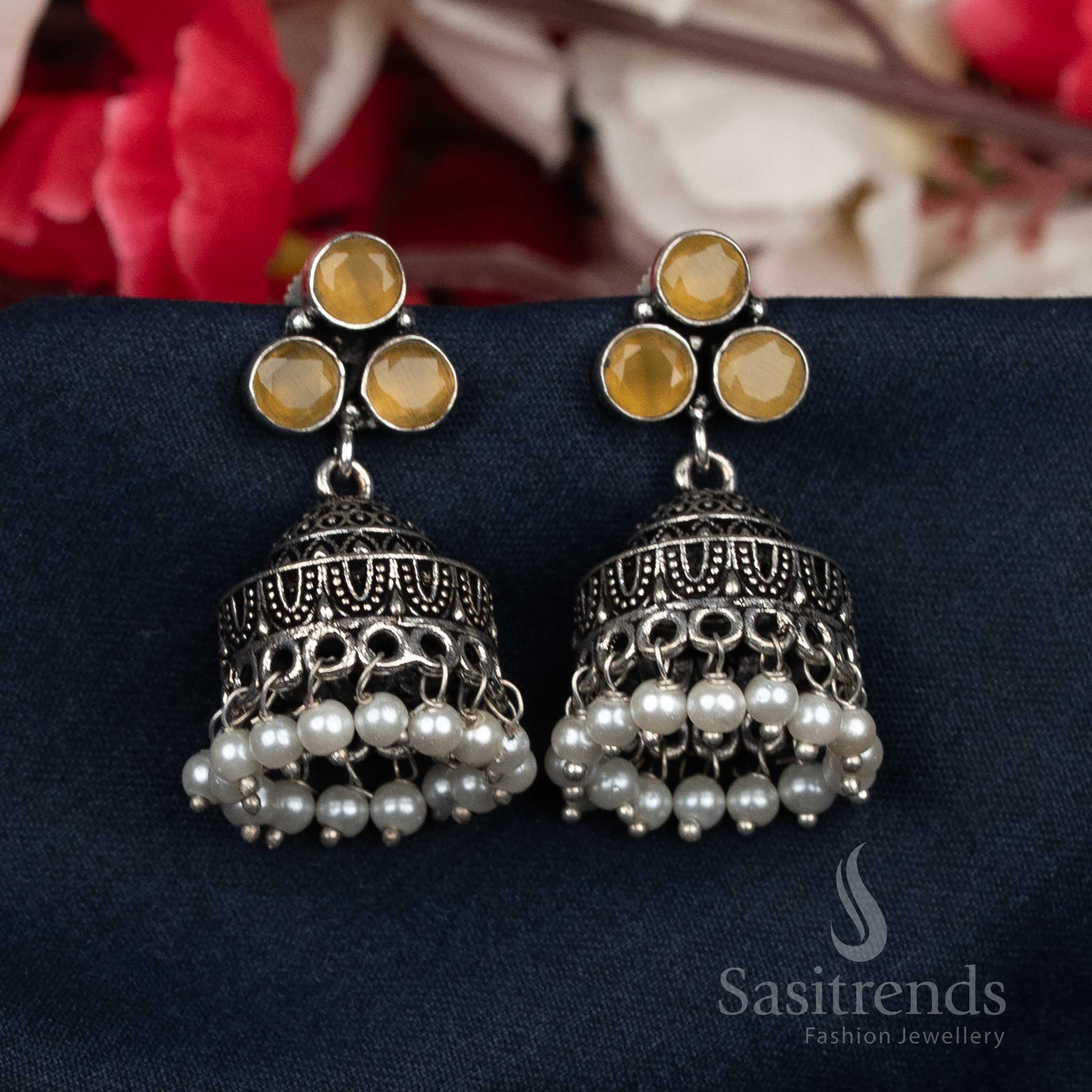 Radiant oxidised yellow Jhumka earrings adorned with pearl bead clusters and gleaming stud tops – a festive designer jewellery piece for joyful occasions – Sasitrends