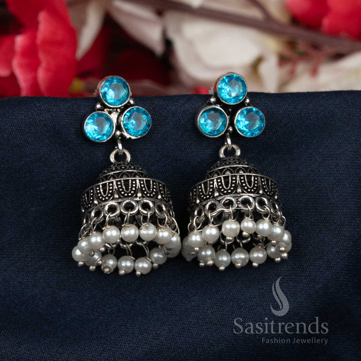 Regal oxidised sky-blue Jhumka earrings featuring clustered pearls and dazzling stud tops – a fine statement jewellery set ideal for sarees and festive occasions – Sasitrends