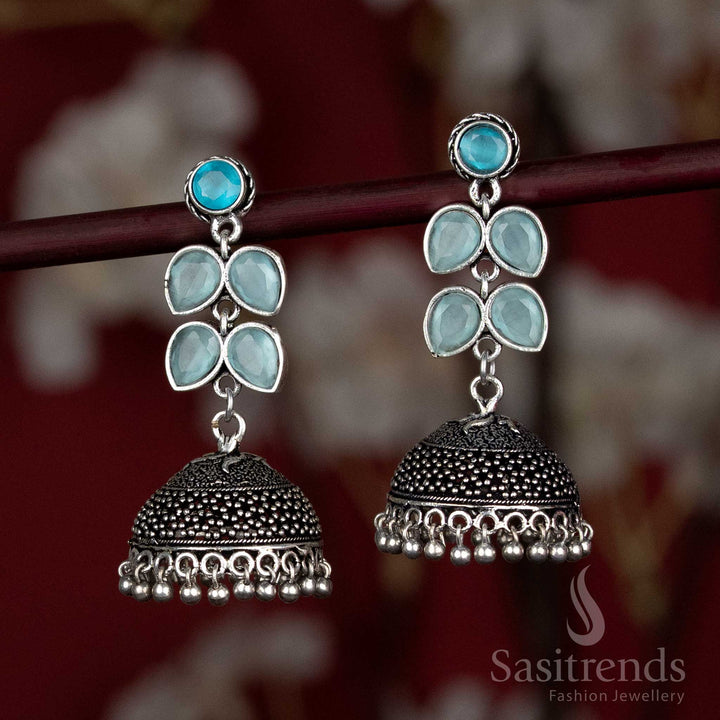 Vibrant ocean-blue oxidised jhumka earrings topped with clustered floral detailing – made for Navaratri dance performances and upbeat ensemble pairings – Sasitrends