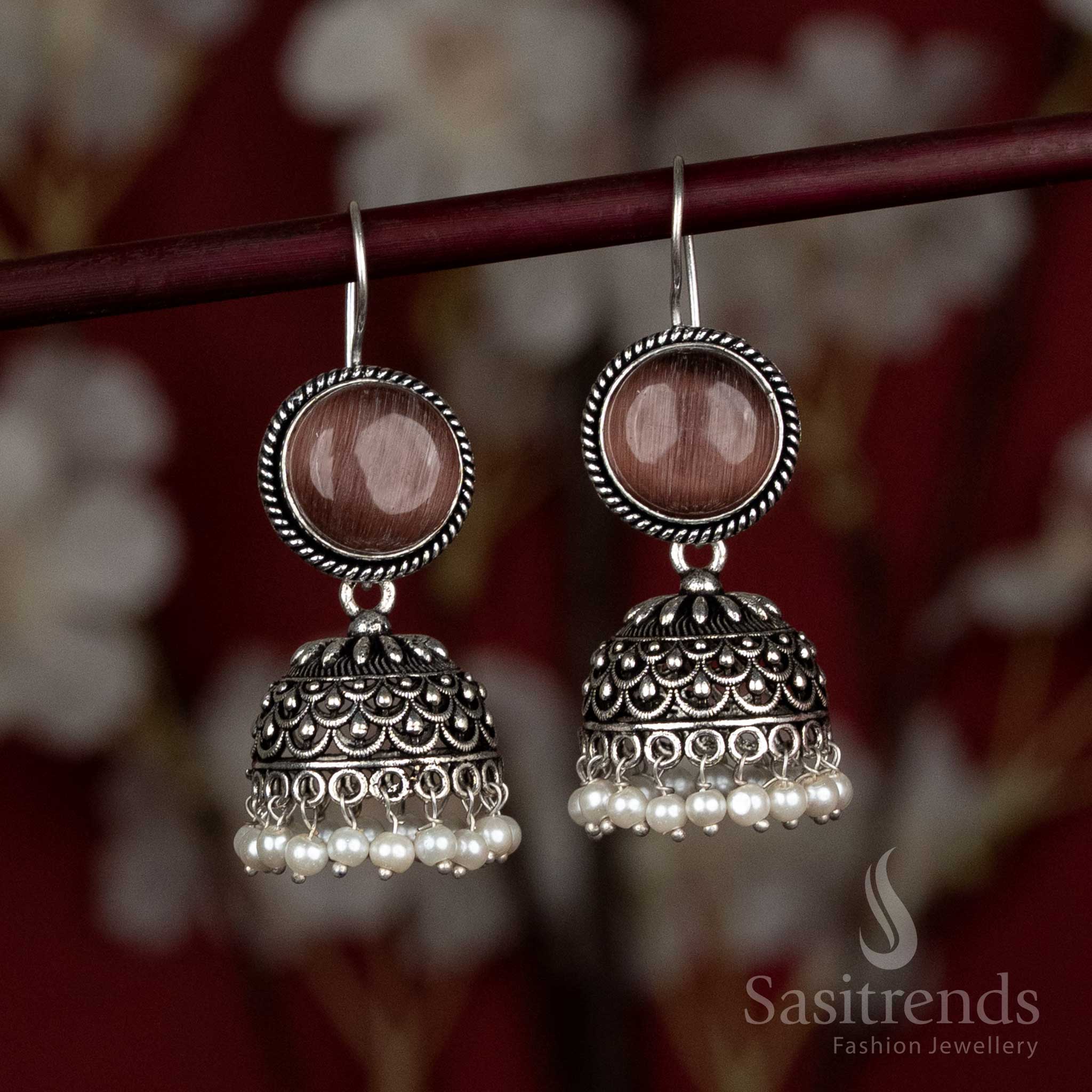 Earthy brown oxidised jhumkas with natural stone studs and pearl drops – styled for Navaratri street fairs, artisan stalls, and flowy ethnic kaftans – Sasitrends