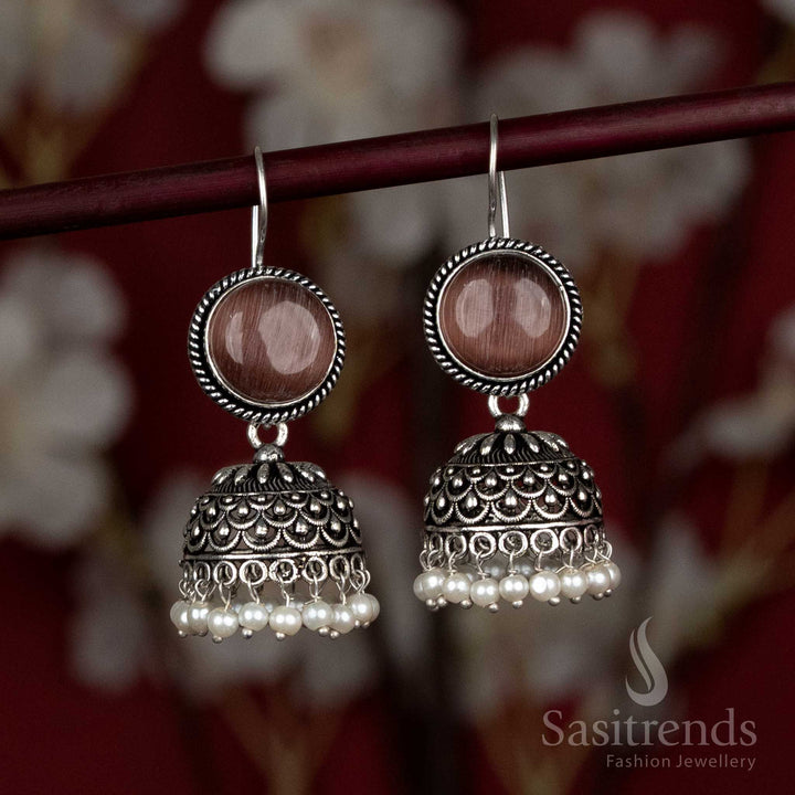 Earthy brown oxidised jhumkas with natural stone studs and pearl drops – styled for Navaratri street fairs, artisan stalls, and flowy ethnic kaftans – Sasitrends