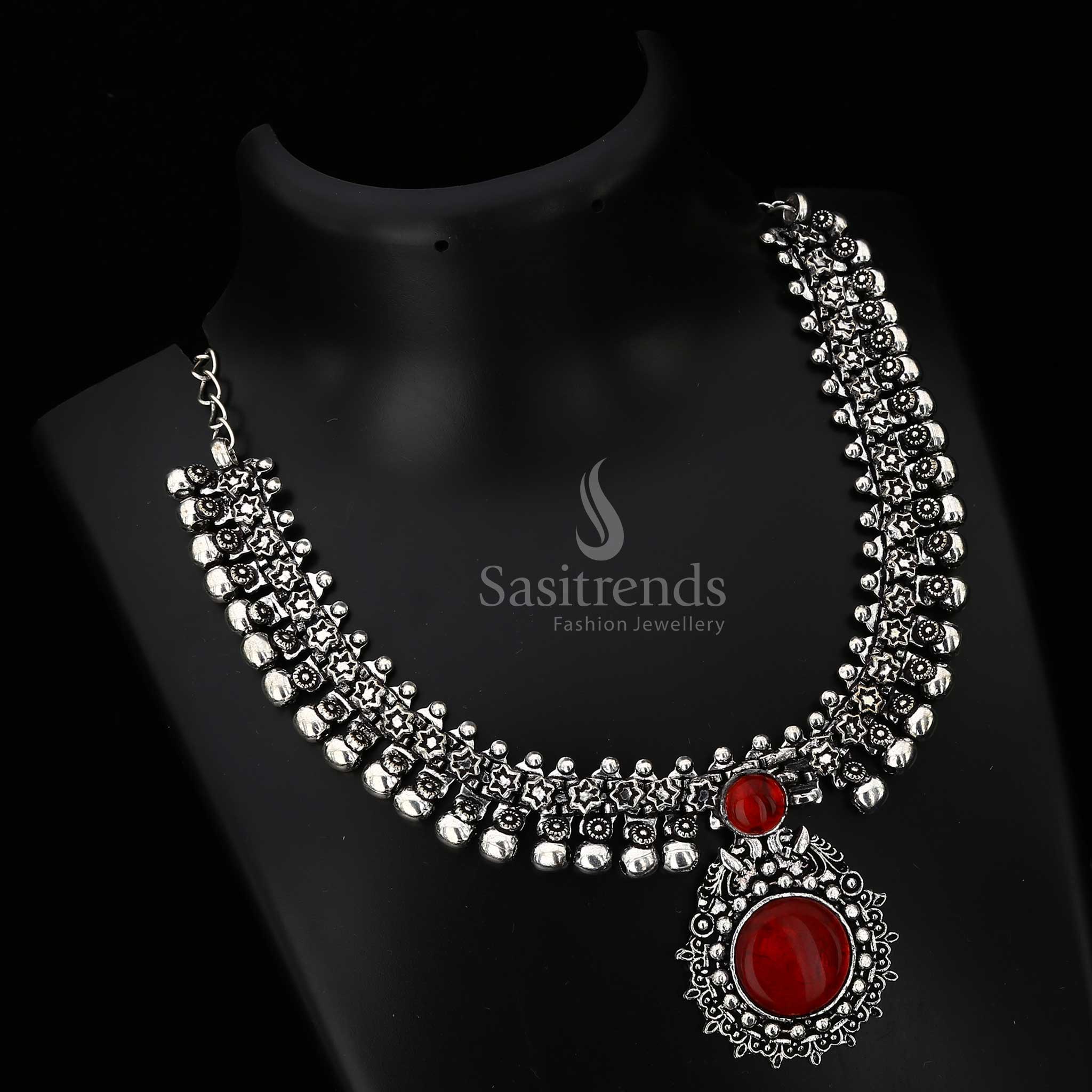 Opulent Haarini oxidised silver necklace with a deep wine red maroon gemstone pendant, perfect for adding refined elegance and subtle drama from Sasitrends
