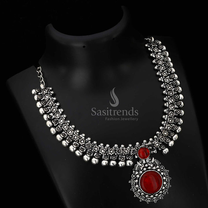 Opulent Haarini oxidised silver necklace with a deep wine red maroon gemstone pendant, perfect for adding refined elegance and subtle drama from Sasitrends