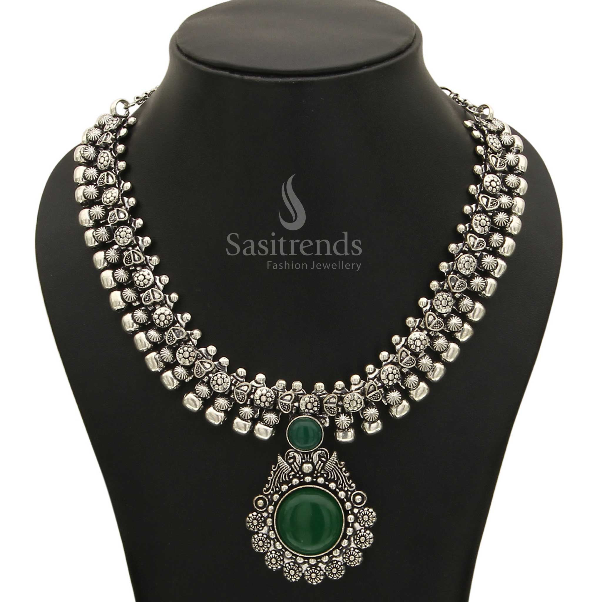 Refreshing Haarini oxidised silver necklace adorned with a lush verdant emerald green gemstone pendant, symbolizing growth and natural beauty from Sasitrends