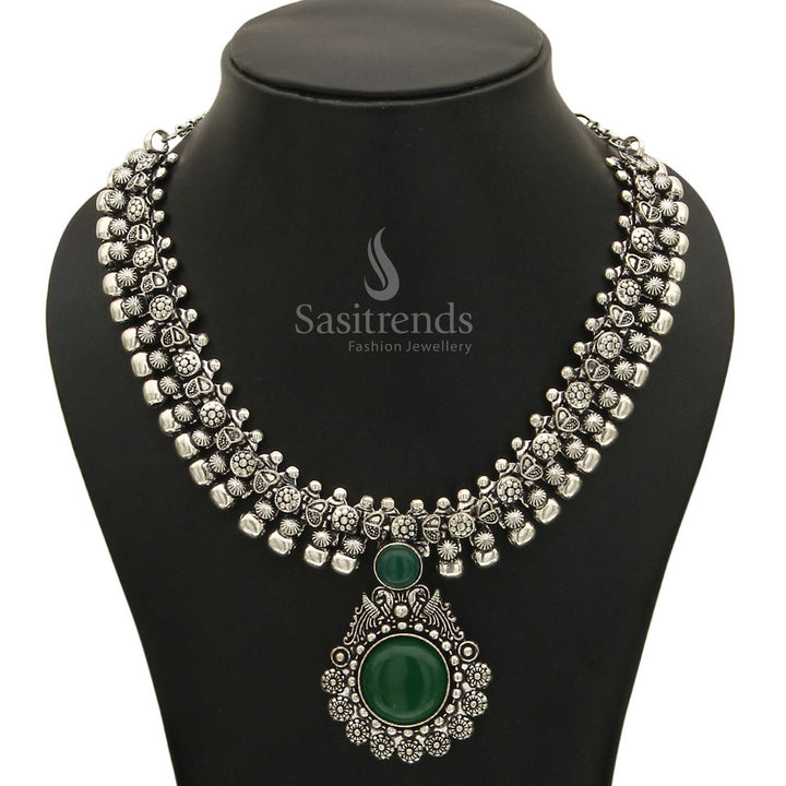 Refreshing Haarini oxidised silver necklace adorned with a lush verdant emerald green gemstone pendant, symbolizing growth and natural beauty from Sasitrends