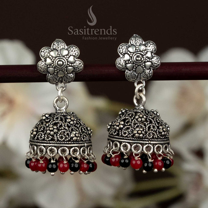 Bold Oxidised Floral Jhumka Earrings With Leaf Motif Studs And Textured Dome In Maroon Black Tone, Designed For Women Seeking Stylish Traditional Jewellery – Sasitrends